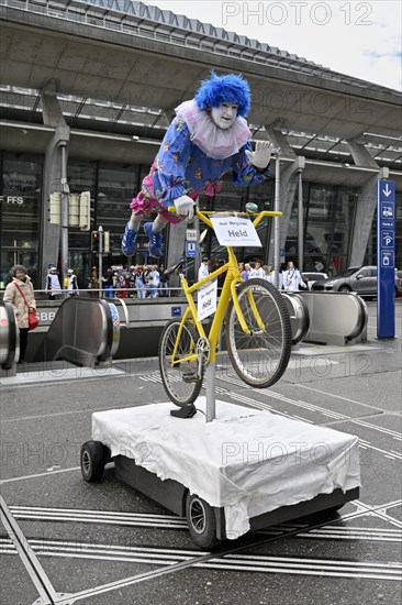 Carnival reveller flying hero on bicycle