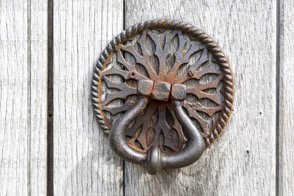 Old iron door handle on church door at Aldham, Suffolk, England, UK