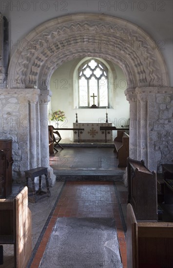 Elaborately decorated stone 12th century Norman chancel arch inside the historic village parish church Marden, Wiltshire, England, UK