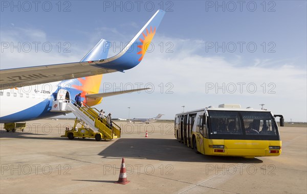 Jet2 package holiday plane passengers disembarking at the airport Faro, Algarve, Portugal with extra wide transport bus