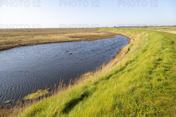 Water in lagoon between shingle beach and sea wall dyke, Alderton, Suffolk, England, UK, North Sea coast landscape