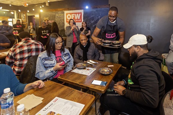 Detroit, Michigan USA, 8 February 2024, Michigan Lt. Governor Garlin Gilchrist spent an hour as a server at Yum Village restaurant to promote the campaign for One Fair Wage. One Fair Wage works for a living minimum wage for all and the elimination of the sub-minimum wage for tipped workers