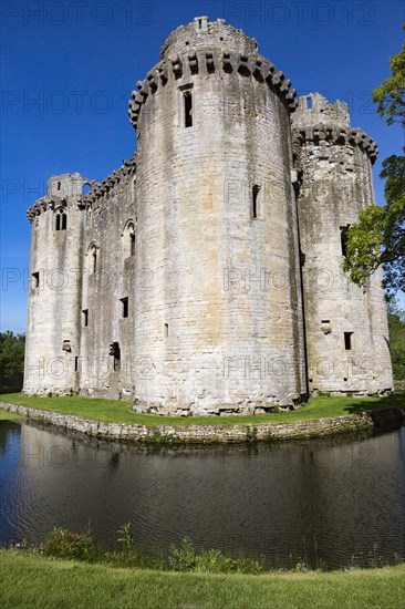Historic stone ruins and moat of Nunney Castle, Somerset, England, UK