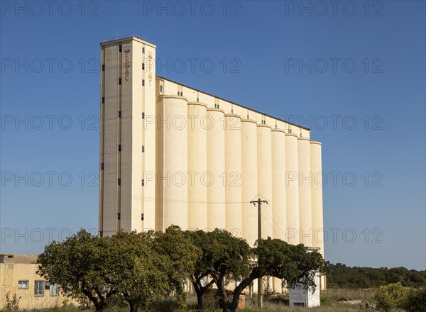 Large EPAC grain cereal silo in arable farming area standing tall against deep blue sky, near Pavia, Alentejo, Portugal southern Europe
