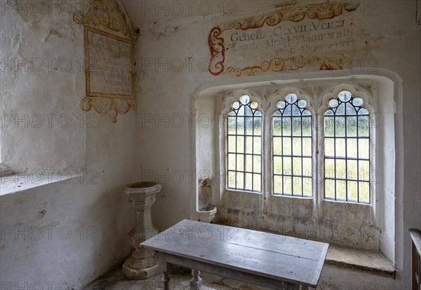 Chancel All Saints church, Leigh, Wiltshire, England, UK interior with ancient wall texts old wooden furniture