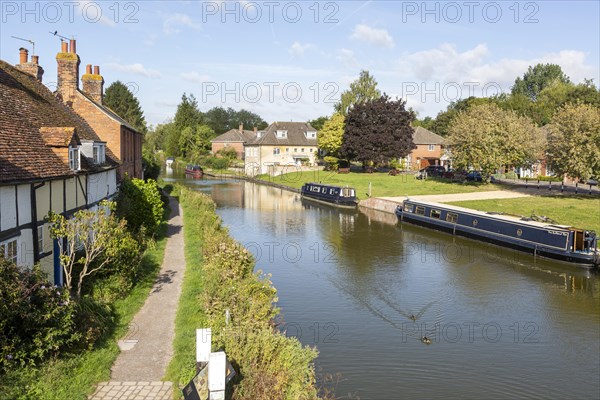 Narrow boats moored on Kennet and Avon canal in town centre of Hungerford, Berkshire, England, UK