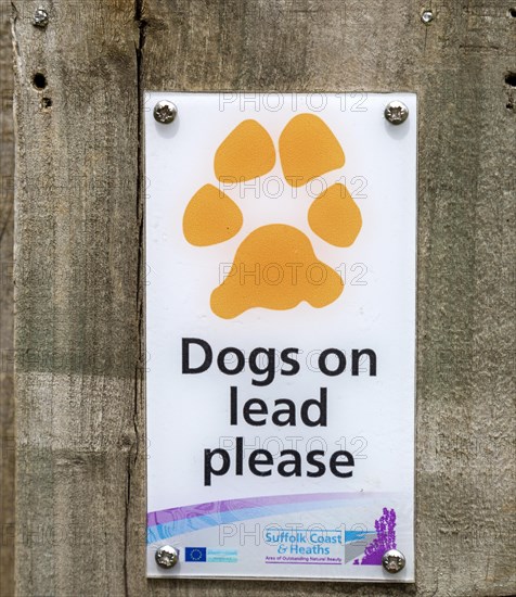 Close up of sign Dogs on Lead Please, Suffolk Coast and Heaths AONB, England, UK