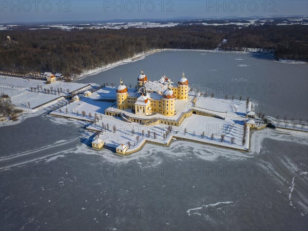 Moritzburg Castle on the castle island surrounded by the frozen castle pond, Moritzburg, Saxony, Germany, Europe