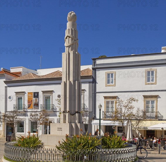 People sitting in sunshine outside street cafes in Praca da Republica, Tavira, Algarve, Portugal, Southern Europe, Europe