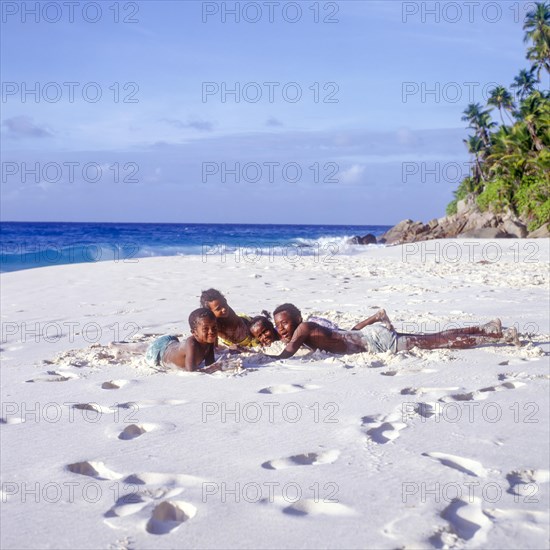 Seychelles, Fregate, local children on the white sandy beach of Anse Victorin, Africa