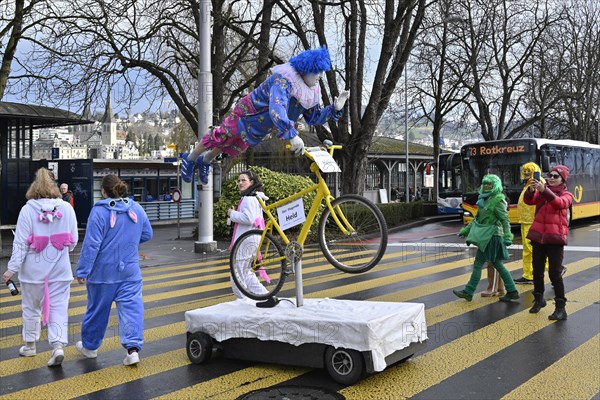 Carnival reveller flying hero on bicycle