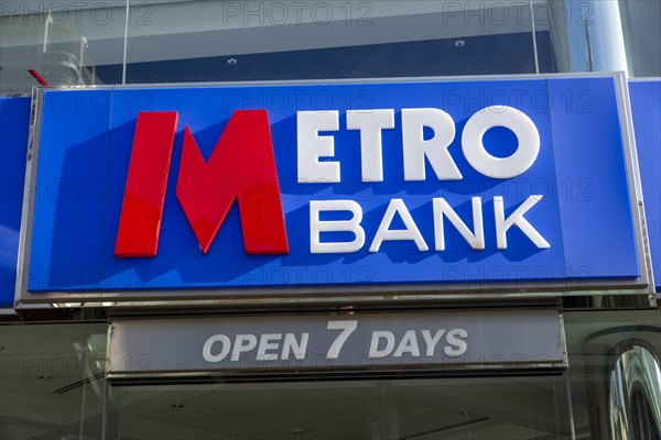 Signs on Metro Bank building, Regent Street, Swindon, Wiltshire, England, UK open 7 days