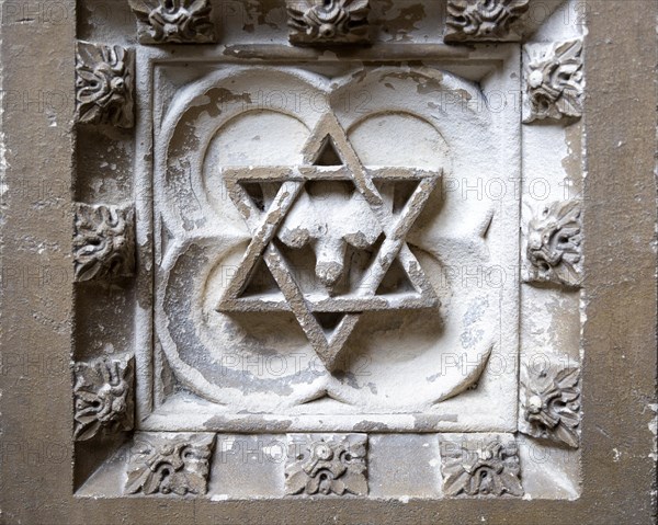 Historic interior of East Bergholt church, Suffolk, England, UK baptismal font stonework detail Star of David