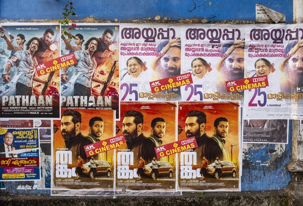 Rows of vibrant Indian Bollywood movie posters adorn a wall in Fort Kochi, Cochin, Kerala, India, Asia