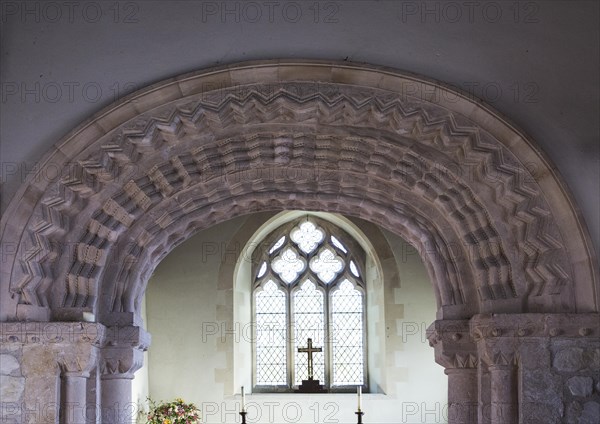Elaborately decorated stone 12th century Norman chancel arch inside the historic village parish church Marden, Wiltshire, England, UK