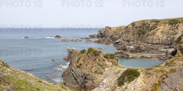 Rocky rugged coastline near fishing port village of Azenha do Mar, Alentejo Littoral, Portugal, southern Europe, Europe