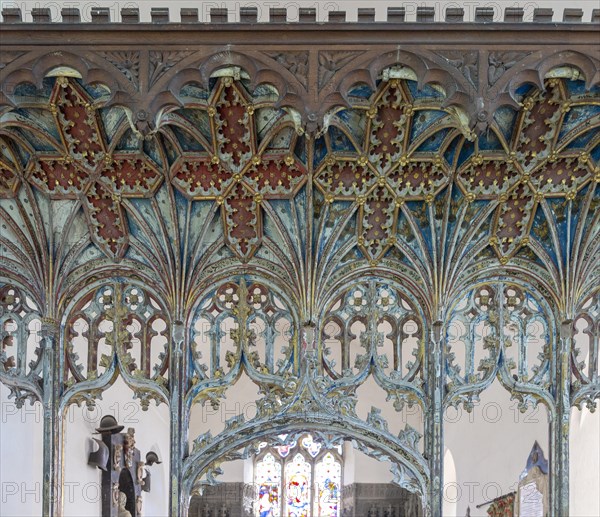 Elaborately decorated wooden rood screen in church of Saint Andrew, Bramfield, Suffolk, England, UK