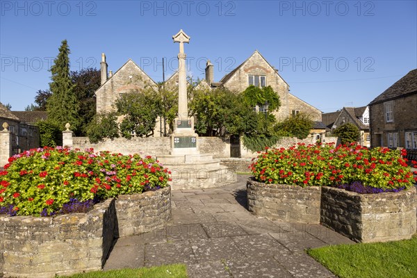 Historic Cotswold stone buildings and war memorial in Canon Square, Melksham, Wiltshire, England, UK