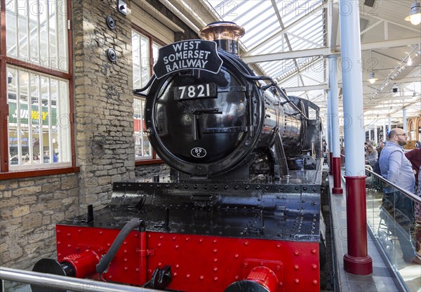 Old steam engine McArthur Glen designer outlet former railway works, Swindon, Wiltshire, England, UK, West Somerset Railway train 7821 Ditcheat Manor