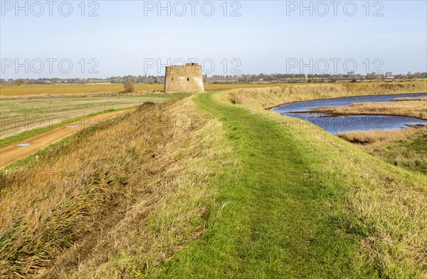 Martello tower Z from footpath on sea wall flood defence embankment, Alderton, Suffolk, England, UK