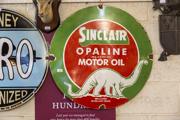 Vintage Sinclair Oplaine motor oil metal advertising sign on display at auction