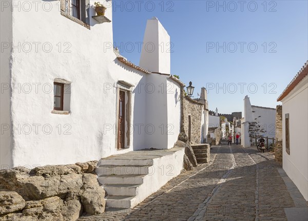Historic cobbled street whitewashed buildings walled hilltop village Monsaraz, Alto Alentejo, Portugal, southern Europe, Europe