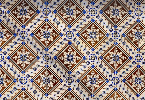 Historic old patterned ceramic tiles on a wall in Portugal