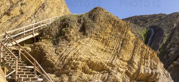 Folded sedimentary rock strata dipping downwards in cliff at Praia dos Alteirinhos, Zambujeira do Mar, Parque Natural do Sudoeste Alentejano e Costa Vicentina, Costa Vicentina and south west Alentejo natural park, Zambujeira do Mar, Alentejo Littoral, Portugal, southern Europe, Europe