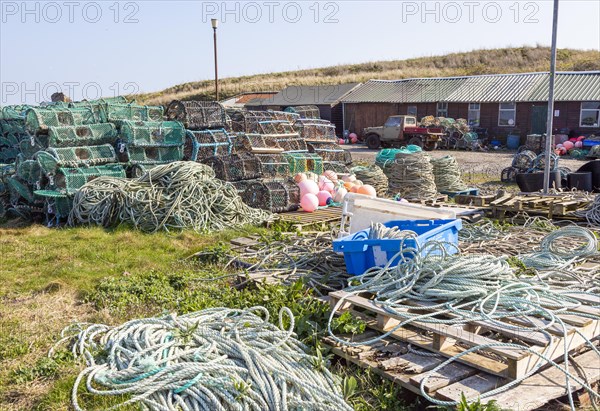 Fishing ropes, lobster pots and equipment on quayside Holy Island, Lindisfarne, Northumberland, England, UK