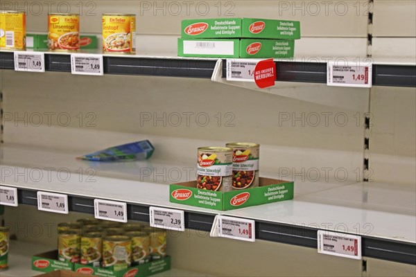 Empty shelf of tins in a supermarket in Germany