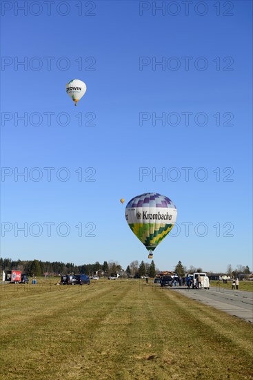 Three hot air balloons take off from the airfield, Montgolfiade Tegernseer Tal, Balloon Week Tegernsee, Warngau, Bavarian Oberland, Upper Bavaria, Bavaria, Germany, Europe
