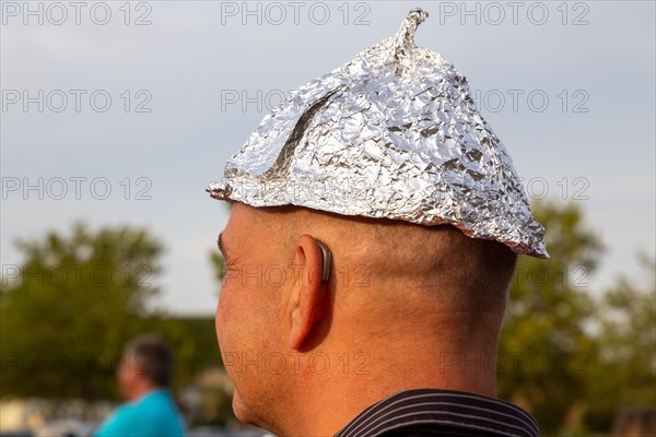 Self-deprecating aluminium hat wearer at a Monday demonstration against the corona measures in Bad Duerkheim under the motto Talking together, finding common ground