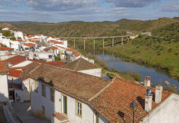 Landscape view of valley of river Rio Guadiana over rooftops in the medieval village of Mertola, Baixo Alentejo, Portugal, Southern Europe, Europe