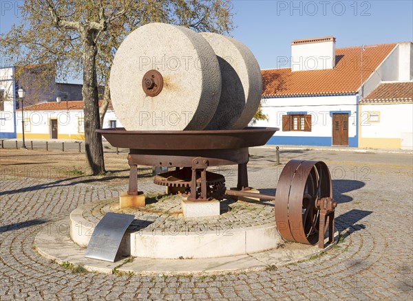 Husk mill historic olive oil press with granite millstones used until 1970s now a heritage monument to a former industrial past, village of Alvito, Beja district, Baixa Alentejo, Portugal, southern Europe, Europe