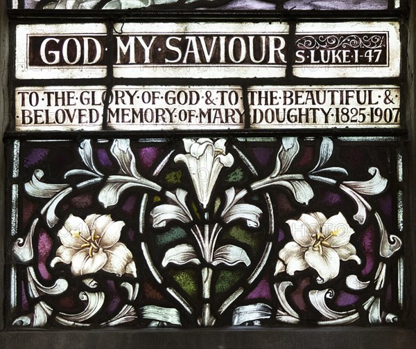 Stained glass window church of Saint Mary, Martlesham, Suffolk, England, UK by Heaton, Butler and Bayne early 1900s lilies floral decoration design detail