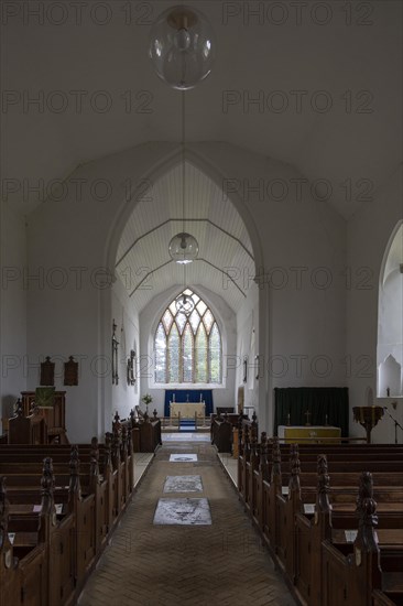 Interior village parish church of Saint Peter, Westleton, Suffolk, England, UK chancel arch and east window