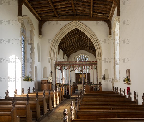 Village parish church Parham, Suffolk, England, UK view of chancel arch rood screen and east window