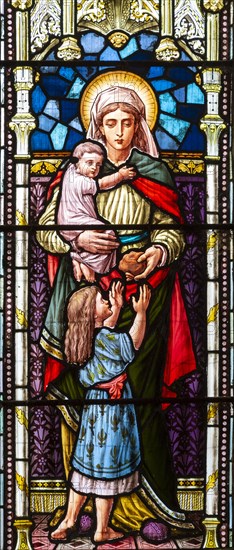 Stained glass window depicting Caritas or Charity, Bedingfield church, Suffolk, England, UK c 1881 W G Taylor