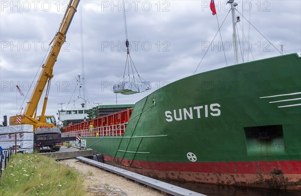 Crane unloading cargo ship Suntis at Anglo-Norden timber merchants, Wet Dock, Ipswich, Suffolk, England, UK