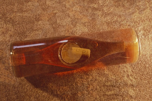 Multiple exposure of a rose wine bottle with wine cork, wine bottle, rose wine, full, view from above, wine-growing region, red, monochrome, studio shot, photo art, double exposure, Ruedesheim, Rheingau, Taunus, Hesse, Upper Middle Rhine Valley, Middle Rhine Valley, Germany, Europe