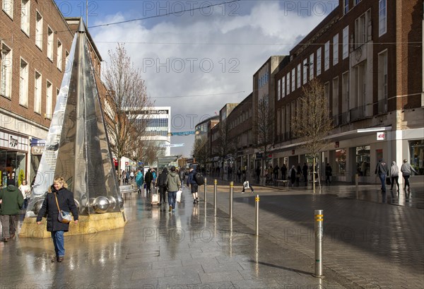 Wet pavements sunshine after rain show High Street, Exeter, Devon, England, UK