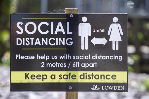 Social Distancing 2 metres apart information notice sign in Lowden garden centre shop, Wiltshire, England, UK, May 2020