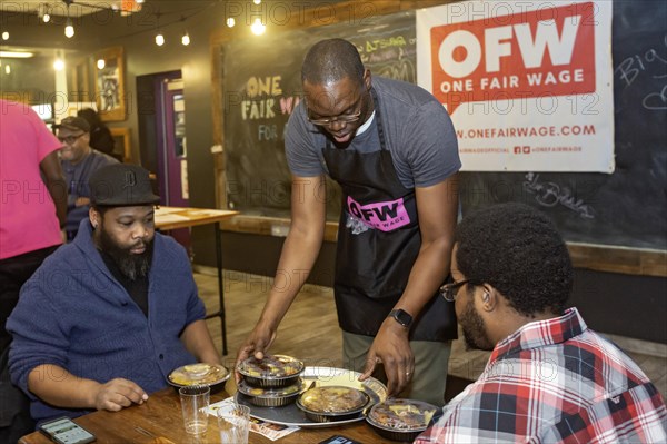 Detroit, Michigan USA, 8 February 2024, Michigan Lt. Governor Garlin Gilchrist spent an hour as a server at Yum Village restaurant to promote the campaign for One Fair Wage. One Fair Wage works for a living minimum wage for all and the elimination of the sub-minimum wage for tipped workers