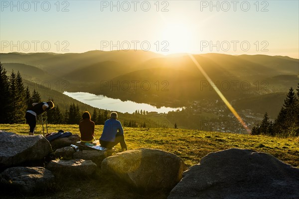 Hiking group, view from Hochfirst to Titisee and Feldberg, sunset, near Neustadt, Black Forest, Baden-Wuerttemberg, Germany, Europe