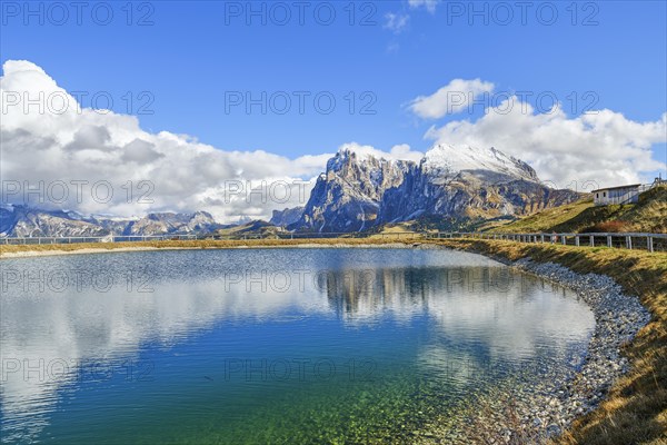 Reservoir with view of the Sassolungo and Sassopiatto, reflection, clouds, Dolomites, Alpe di Siusi, South Tyrol