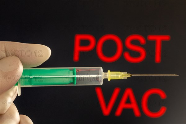 Symbolic image of vaccination damage caused by the corona vaccination: close-up of an injection needle, with the words Post Vac in the background. The debate about possible vaccine damage is currently gaining momentum in Germany