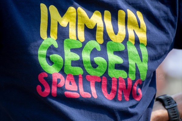 Immune to division. A man wears a T-shirt with this inscription at a peace demonstration in Ramstein