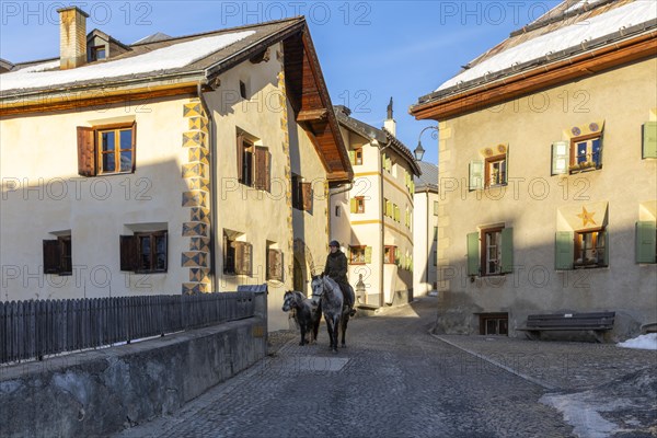 Horsewoman on horseback, historic houses, sgraffito, facade decorations, historic village, Guarda, Engadin, Grisons, Switzerland, Europe