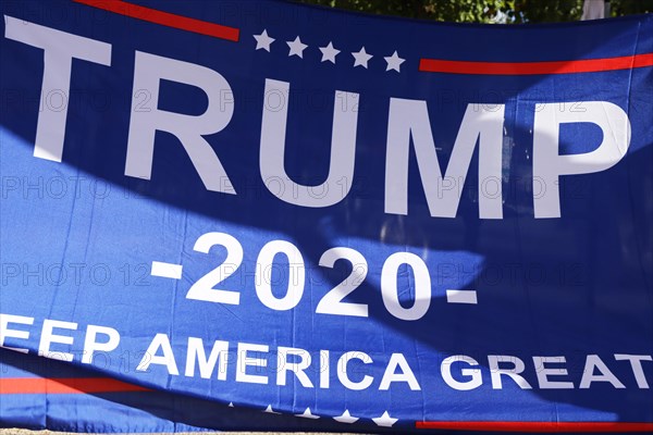 Convinced Trump supporters in Germany hold up a banner with the campaign slogan Trump 2020 - keep America great