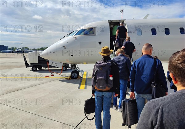 Passengers with hand luggage boarding a small aircraft on the tarmac, Duesseldorf Airport, North Rhine-Westphalia, Germany, Europe
